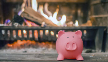 Savings,Concept.,Piggy,Bank,With,Fireplace.,Energy,Saving,Concept.,Pink