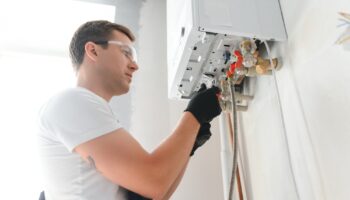 Professional,Plumber,Checking,A,Boiler,And,Pipes,,Boiler,Service,Concept.