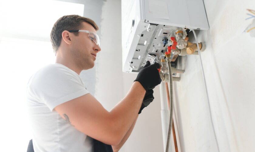 Professional,Plumber,Checking,A,Boiler,And,Pipes,,Boiler,Service,Concept.